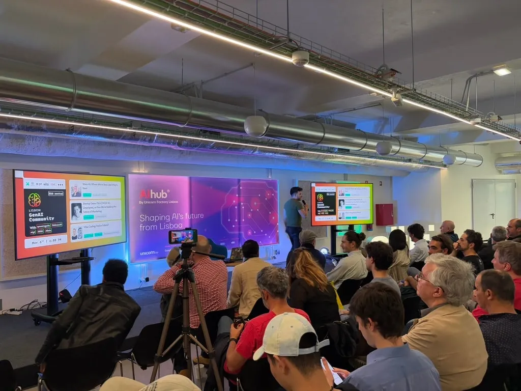 Wide view of an Embrace:AI meetup venue with the audience seated