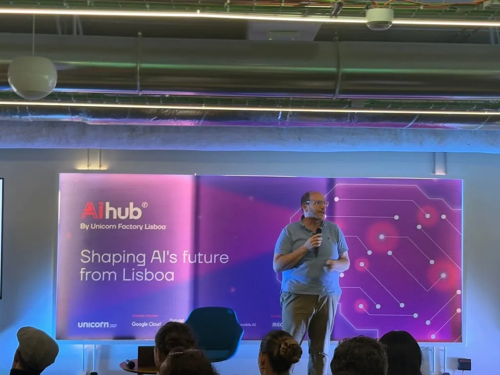 A speaker on stage at the AI Hub venue in Lisbon